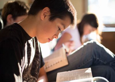 young boy reading his scriptures